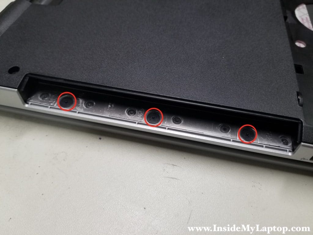 Three screws located in CD/DVD bay