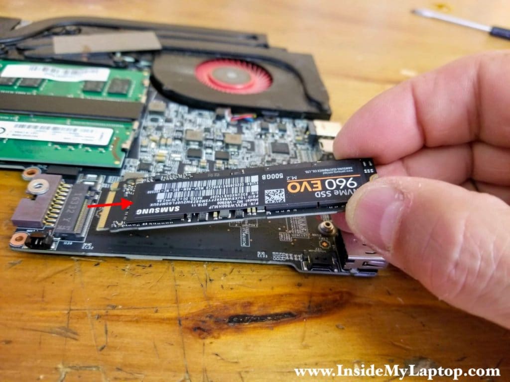 Remove one screw securing the NVMe SSD and pull the drive out.