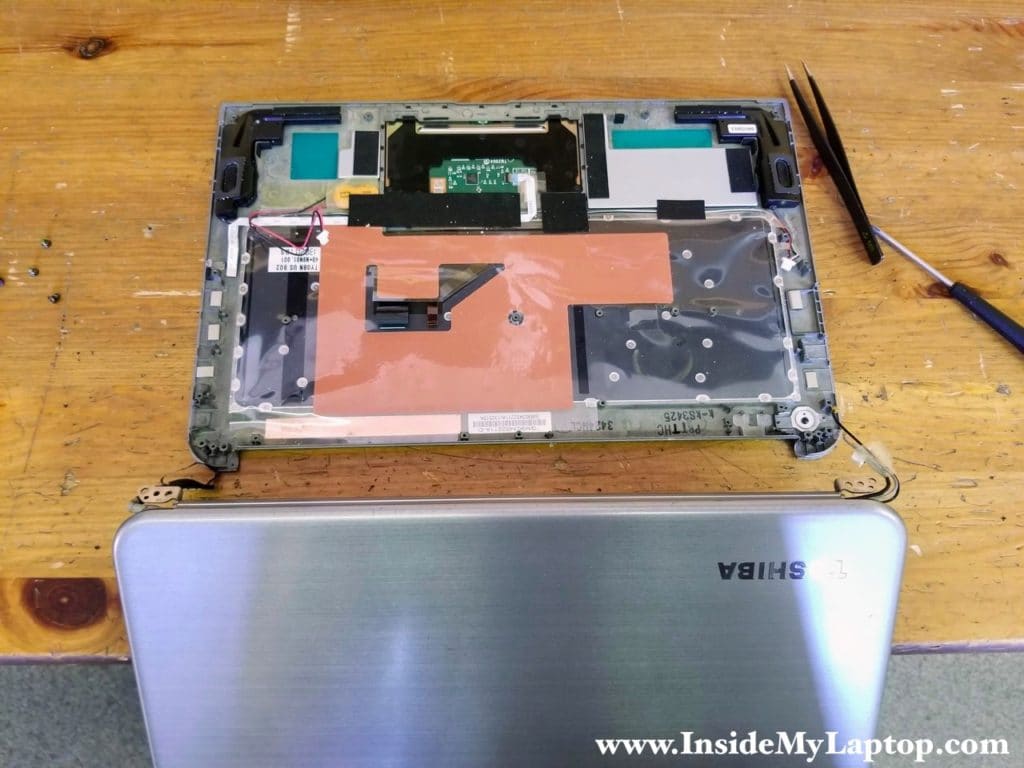 Separate the display assembly from the top case and remove it.