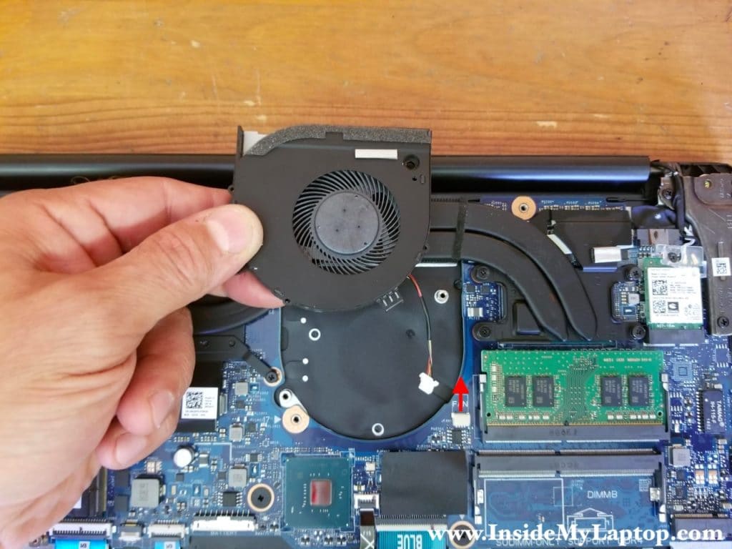 Lift up the left cooling fan and disconnect it from the motherboard.