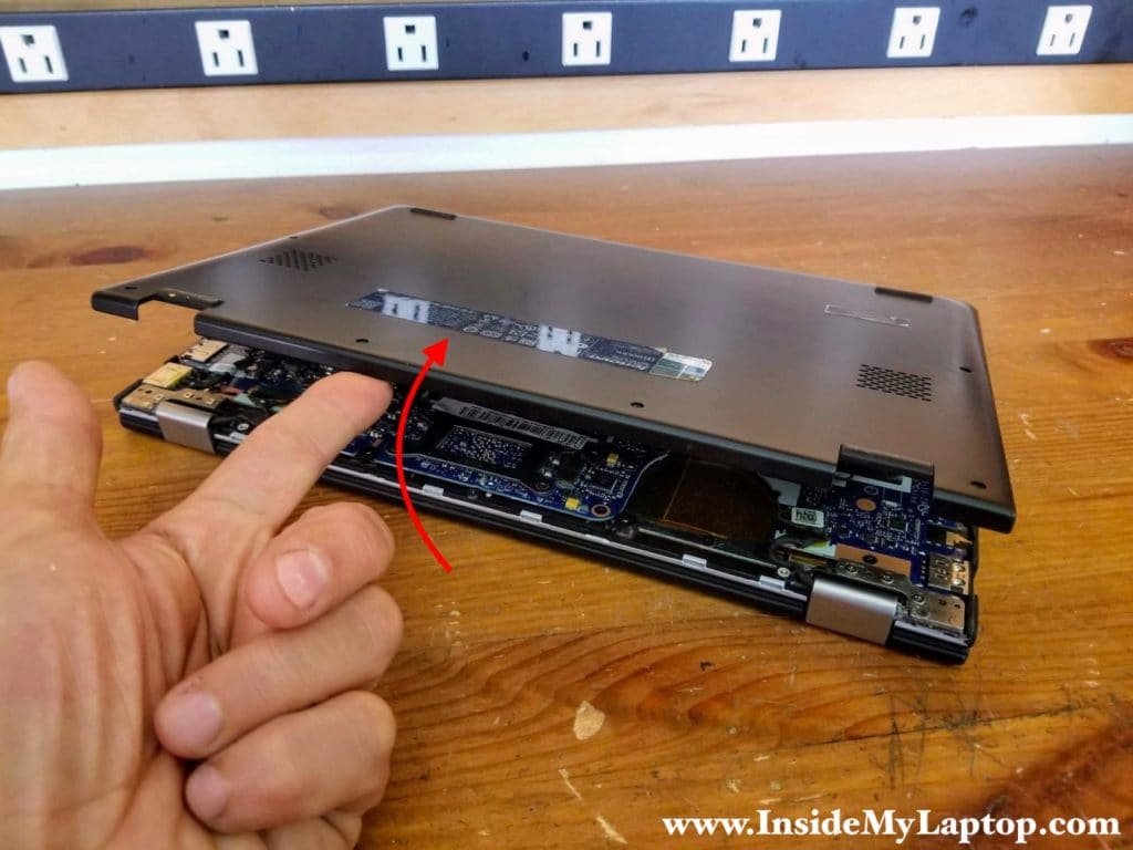 Start removing the base cover from the back side of the laptop.