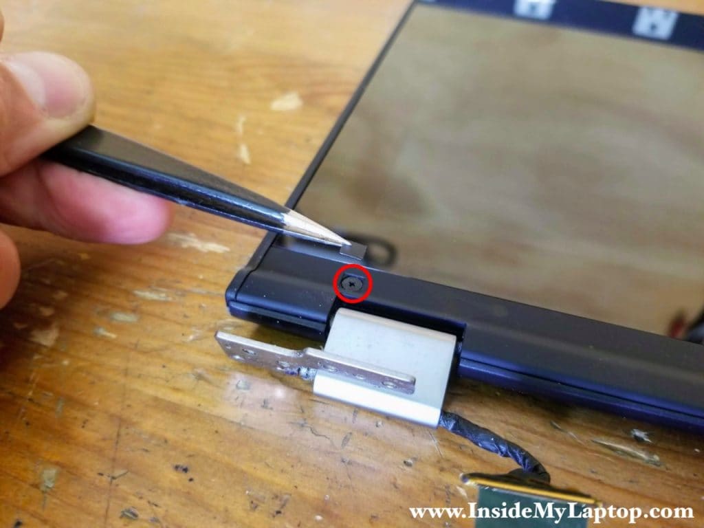 Remove one screw from the lower left side of the display.