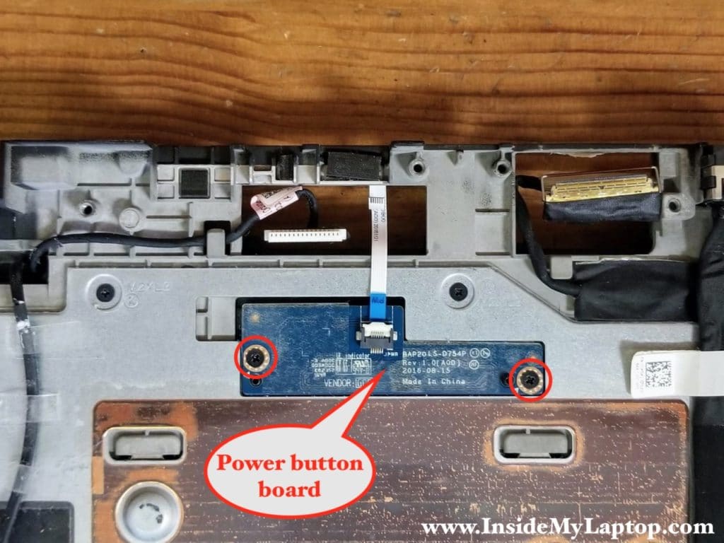 The power button board secured to the palmrest with two screws.