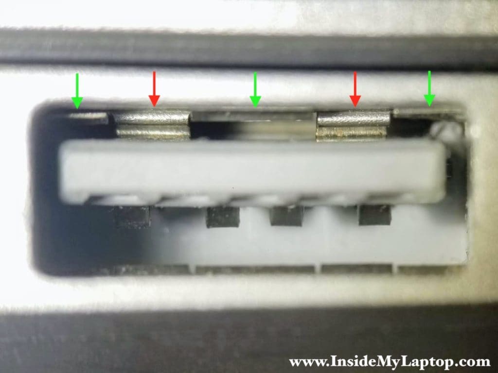 Two grounding strips (pointed with red arrows) are bent and they are touching the plastic contact support block.