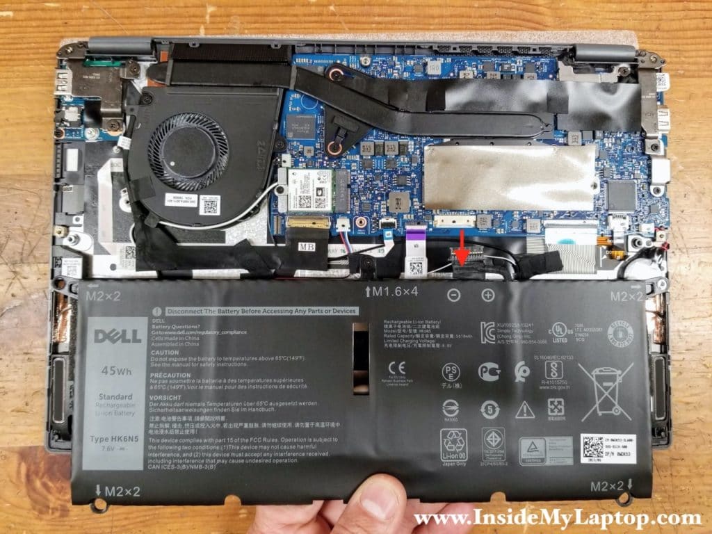 Lift up the battery and disconnect the cable from the motherboard.