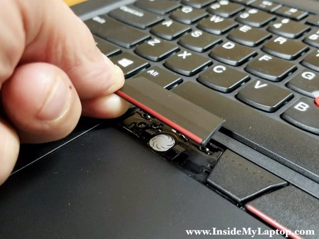 Remove the left trackpad button and after that remove the right button the same way.