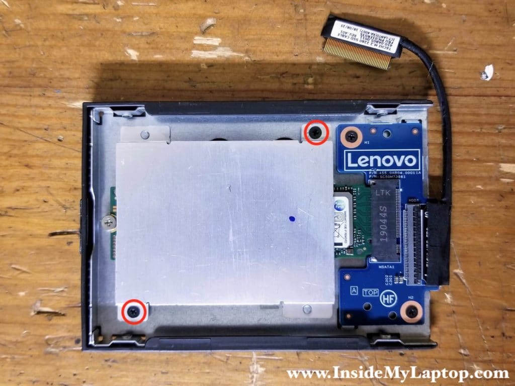 Remove two screws from the SSD heatsink and remove it.