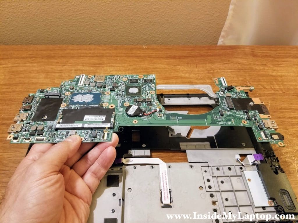 Lift up the motherboard and remove it from the top case.