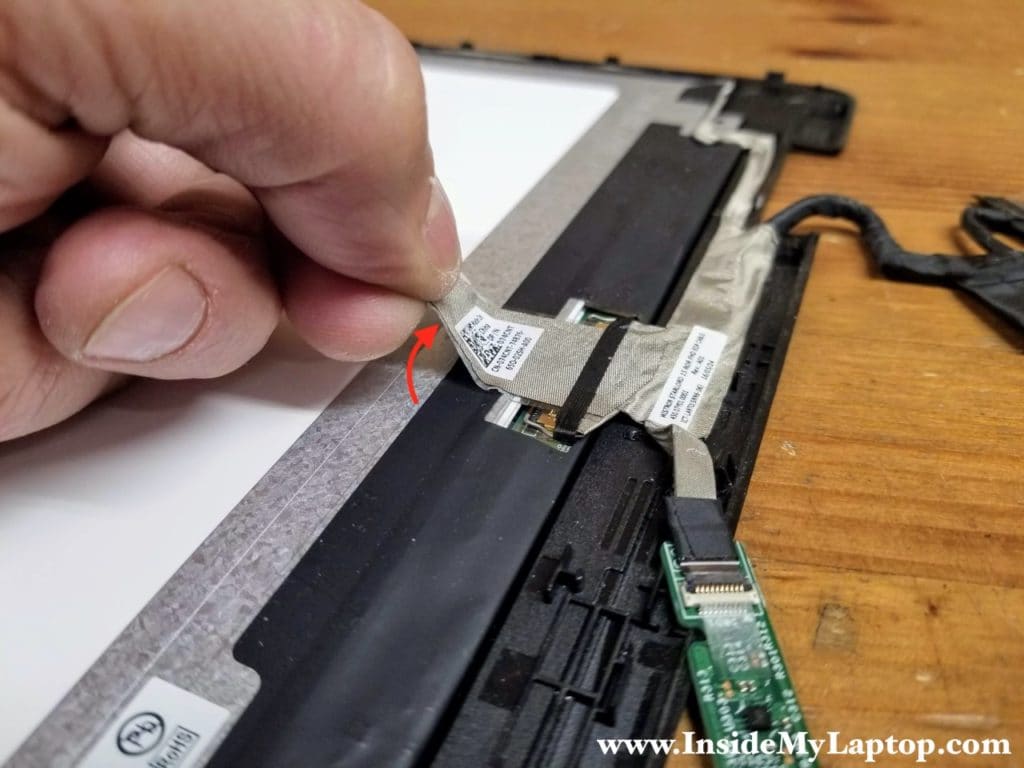 Peel off the sticky tape securing the display video cable connector.