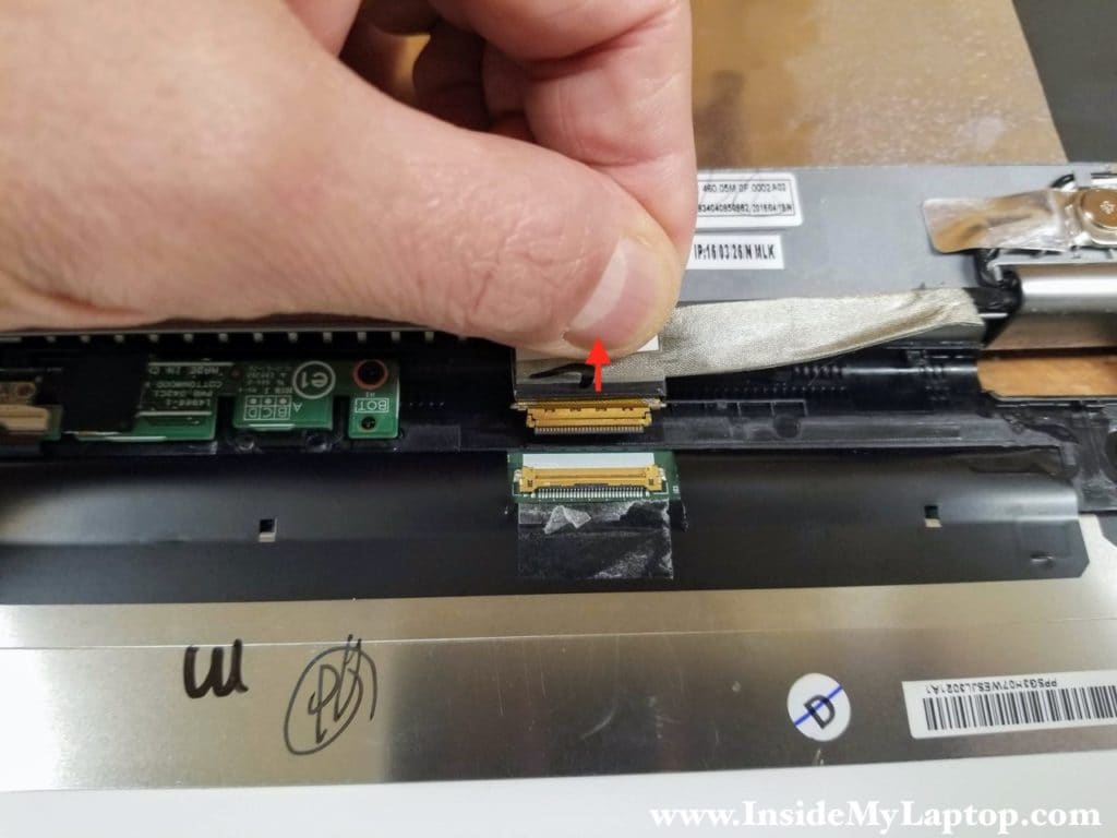 Pull the video cable out of the connector on the back of the screen.