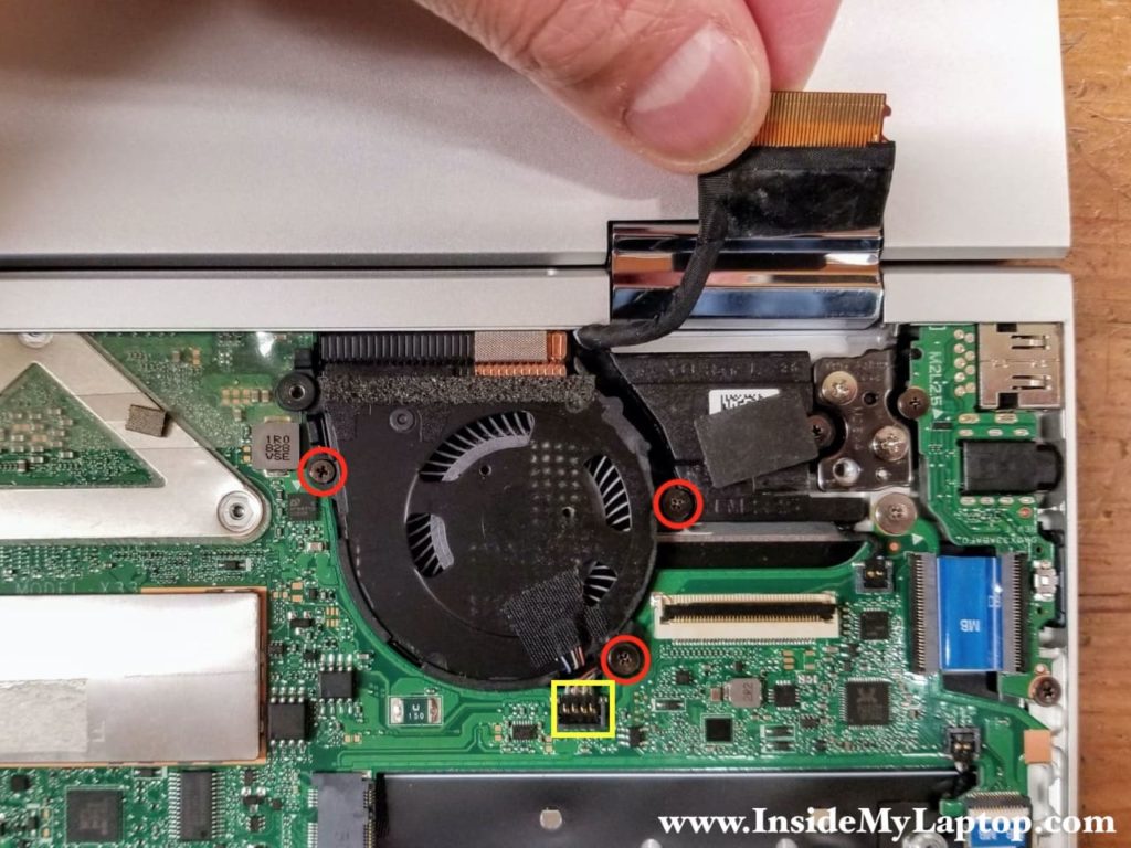 Remove three screws from the left fan and disconnect the fan cable.