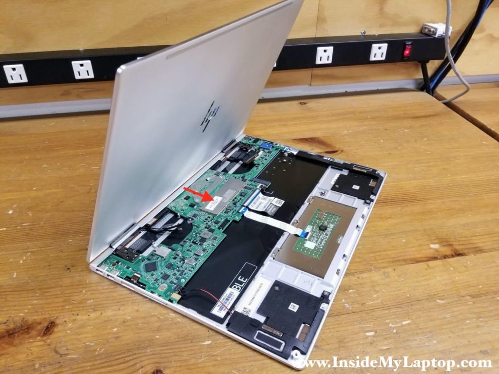 Move the display panel towards the touchpad to separate it from the top case assembly.