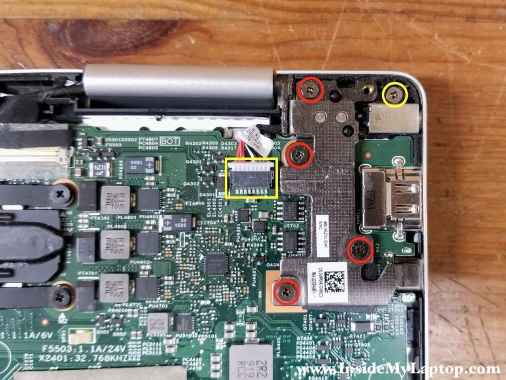 Remove four screws securing the display hinges. Remove one screw from the DC power jack and disconnect the DC jack cable from the motherboard.