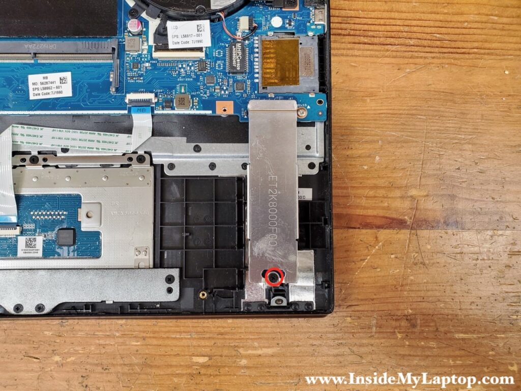 Remove one screw holding the cover and the SSD in place.