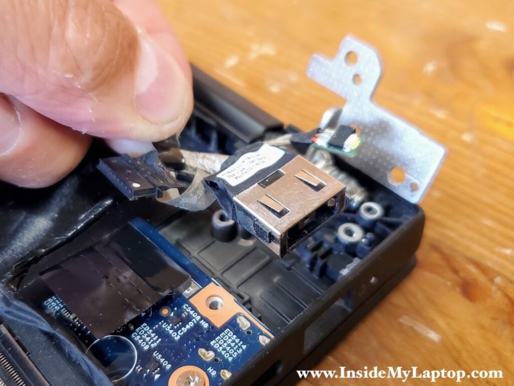 Disconnect the DC jack cable from the motherboard and remove it.
